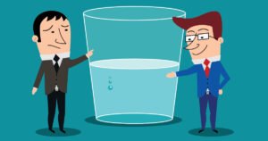 Bicchiere con acqua a metà su sfondo chiaro – metafora del pensiero positivo o negativo